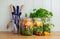 Salad in glass storage jars on kitchen worktop.