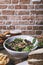 Salad with goat cheese, homemade hamburgers with french fries, drink and cake on the wooden table. Isolated vertical image