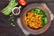 Salad from green beans, stewed with onions in tomato sauce and green leaves of arugula