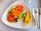 Salad with hummus and nachos served on plate