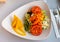 Salad with hummus and nachos served on plate