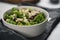 Salad with kale, cranberries and almond flakes in white bowl on linen napkin