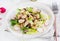 Salad king oyster mushrooms with sesame seeds, radish and lettuce on a plate.