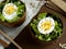 Salad of lettuce leaves and eggs in wooden bowls seeds cumin loaves Dark background