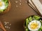 Salad of lettuce leaves and eggs in wooden bowls seeds cumin loaves Dark background