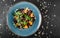 Salad with liver, arugula, orange, spinach and almonds on plate over dark stone surface. Healthy food concept