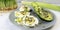 Salad of microgreens, avocado, boiled eggs, leek and arugula, on a plate, top view