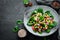 Salad with mushrooms, spinach, Turkish peas and onion in a plate on a wooden background Top view. Free space for your text. Flat