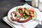 salad with octopus, tomatoes, olives and arugula. fresh healthy salad