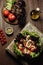 Salad on an old wooden board. Black Zebra cherry tomatoes