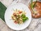 Salad with pasta, shrimp, green peas and decorated herbs