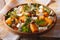 Salad with persimmon, arugula, oranges and cheese. Horizontal, r