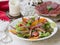 Salad with persimmon, ham, cherry tomatoes and garnet. Festive dish . Christmas dinner. Selective focus, close up, copy space