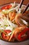 Salad with pig ears and vegetables in a bowl macro. vertical