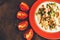 Salad on the plate with tomatoes on the dark background.