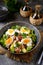 Salad with potatoes, bacon, olives, feta cheese, egg and lettuce.