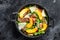 Salad with Prosciutto, peach and arugula. Cold snacks. Black background. Top view