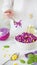 Salad of red cabbage and corn. Woman`s hand holds fork with sala