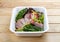 Salad with roast beef sous-vide. Healthy food. Takeaway food. On a wooden background