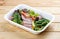 Salad with roast beef sous-vide. Healthy food. Takeaway food. On a wooden background