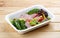 Salad with roast beef sous-vide. Healthy food. Takeaway food. On a wooden background