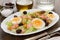 Salad with salmon, eggs and olives on white dish