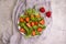Salad with strawberries, appetizing cuisine nuts spring on a concrete background