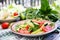 Salad of tomatoes and cucumbers with green onions and basil.