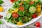 Salad of tomatoes, cucumbers, peppers, arugula and dill.