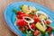 Salad with watermelon, avocado, tomatoes, grapefruit and corn salad