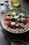 Salad of whole grain cereal spelt with feta cheese, cherry tomatoes and oregano.