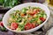 Salads with quinoa, arugula, radish, tomatoes and cucumber