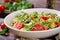 Salads with quinoa, arugula, radish, tomatoes and cucumber