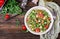 Salads with quinoa, arugula, radish, tomatoes and cucumber