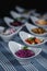 Salads in white plates on the table. Salad from beets, prunes and peanuts in the foreground. In the blurry background