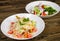 Salads on a wooden background.