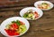 Salads on a wooden background.