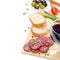 Salami, ciabatta, olives and a glass of wine on a wooden board
