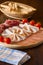 Salami cutting board cherry tomatoes and breadsticks