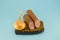 Salami sausage, brown bread and onion on blue background