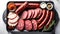 salami sausages, spices and meat products in a wooden tray, Free space for text,