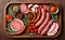 salami sausages, spices and meat products in a wooden tray, Free space for text,