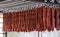 Salami sticks drying on a rack