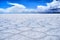 Salar de Uyuni Bolivia salt desert and cloudy blue sky