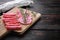 Salchichon dry cured  sausages cut in slices  on old wooden table with copy space