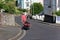 Salcombe Devon England. Man pulling canoe through Town