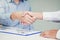 Sale agent and customer handshake and sign agreement contract, I