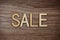 Sale Alphabet Letters on wooden background business concept