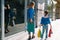 sale, consumerism, money and people concept - happy young woman with shopping bags and credit card in mall.