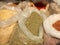 Sale of friable cereals and seasonings in open bags on a bazaar counter. Trade in cereals and medicinal herbs of traditional